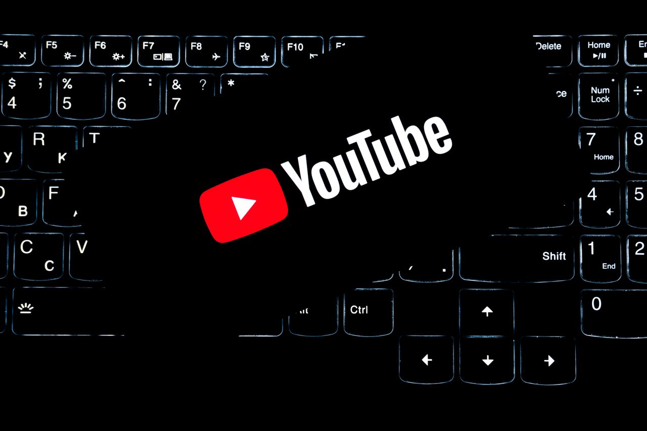 about-us YouTube logo displayed on a backlit keyboard, representing digital media and online content creation.